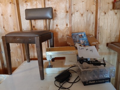 Singer sewing machine with supplies and chair. There are several sewing extras in this lot